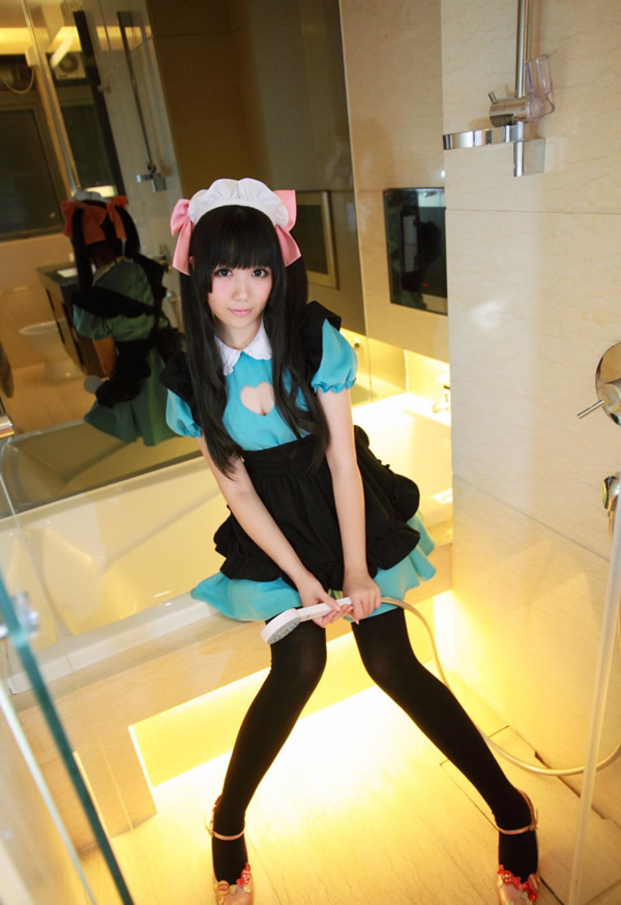 小米穿着绿色女仆装粉红发饰，拿着喷头坐在浴池上