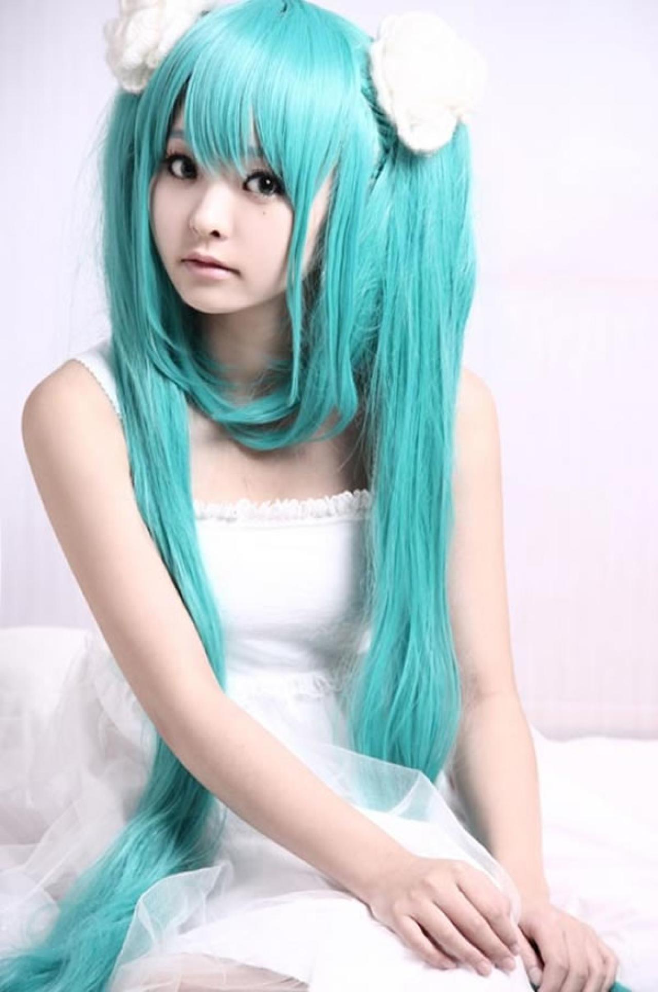 kuuya穿着白色睡衣扮演初音未来，端坐在床上，上半身特写