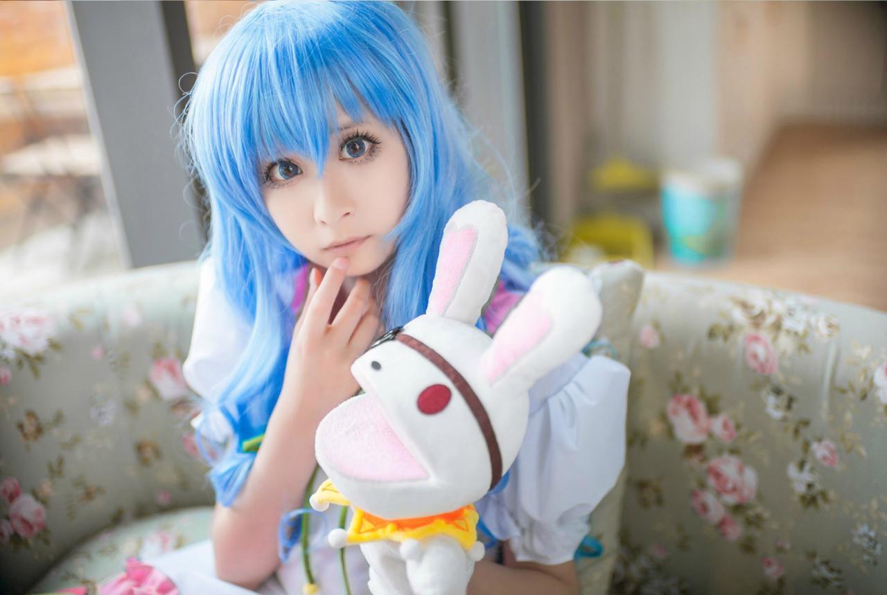 桃小陌扮演四糸乃拿着四糸奈兔子人偶坐在沙发上，手指抵住下巴思考