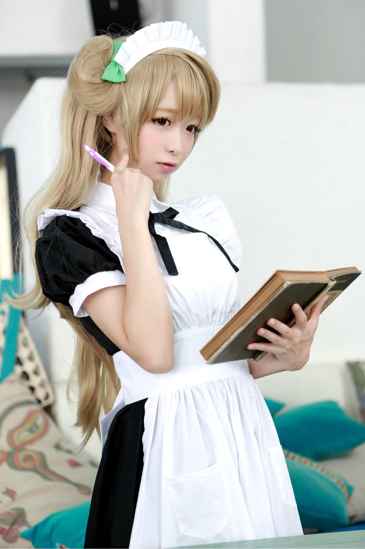 鳄鱼同学扮演南小鸟左手端着打开的书本，右手握着笔，食指按着脸颊，专注思考的样子