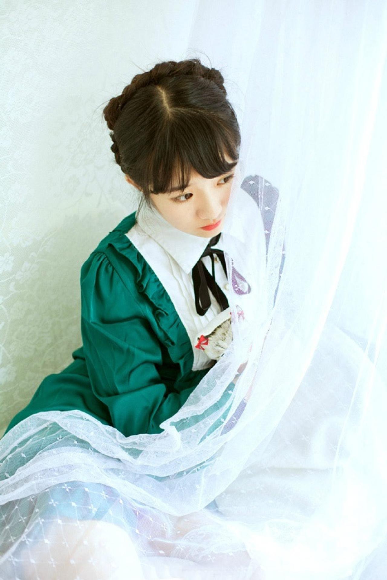 小陆离靠在窗边，抱着玩偶，掀开薄纱向窗外望去