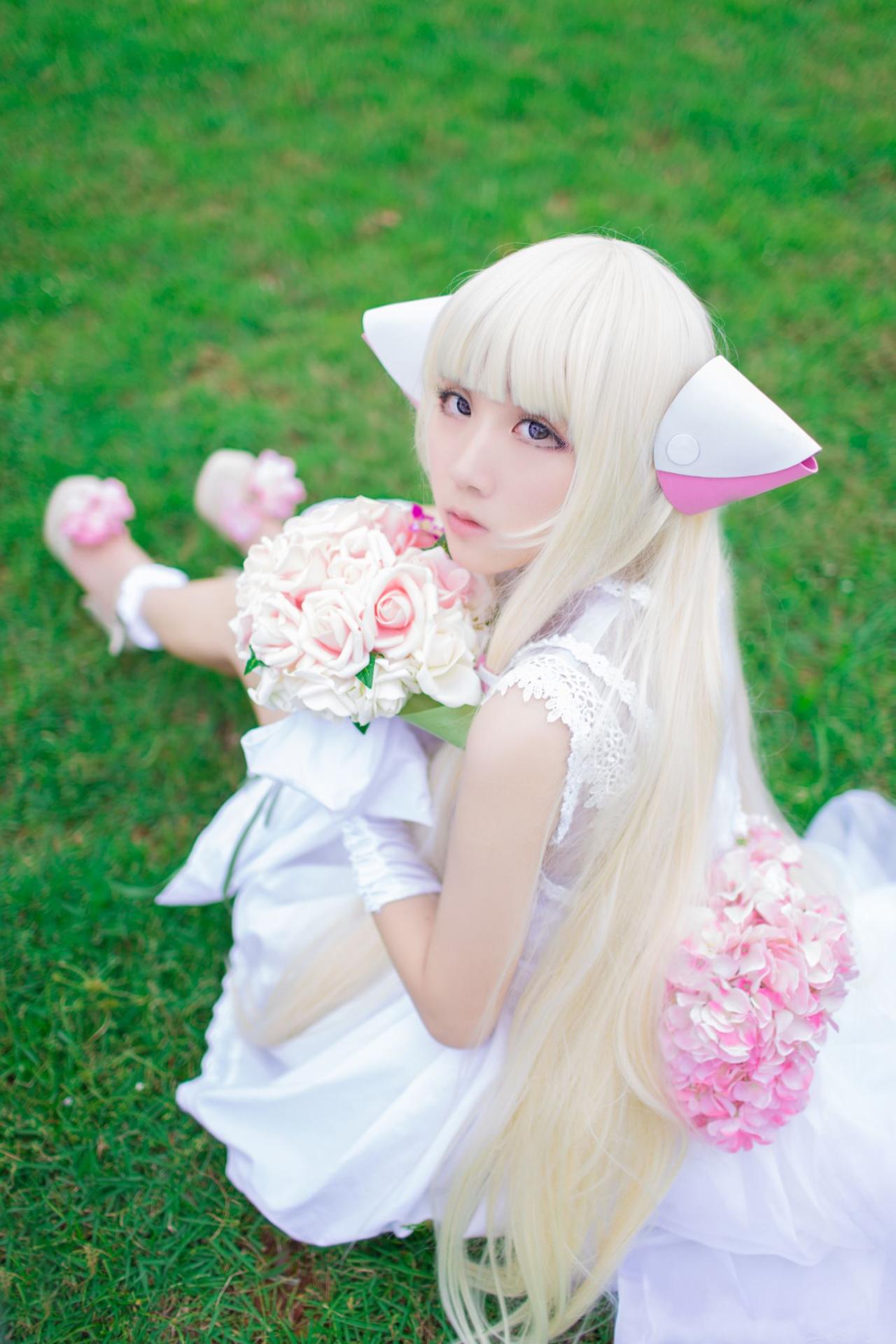 菌子扮演小叽坐在草地上端着手捧花