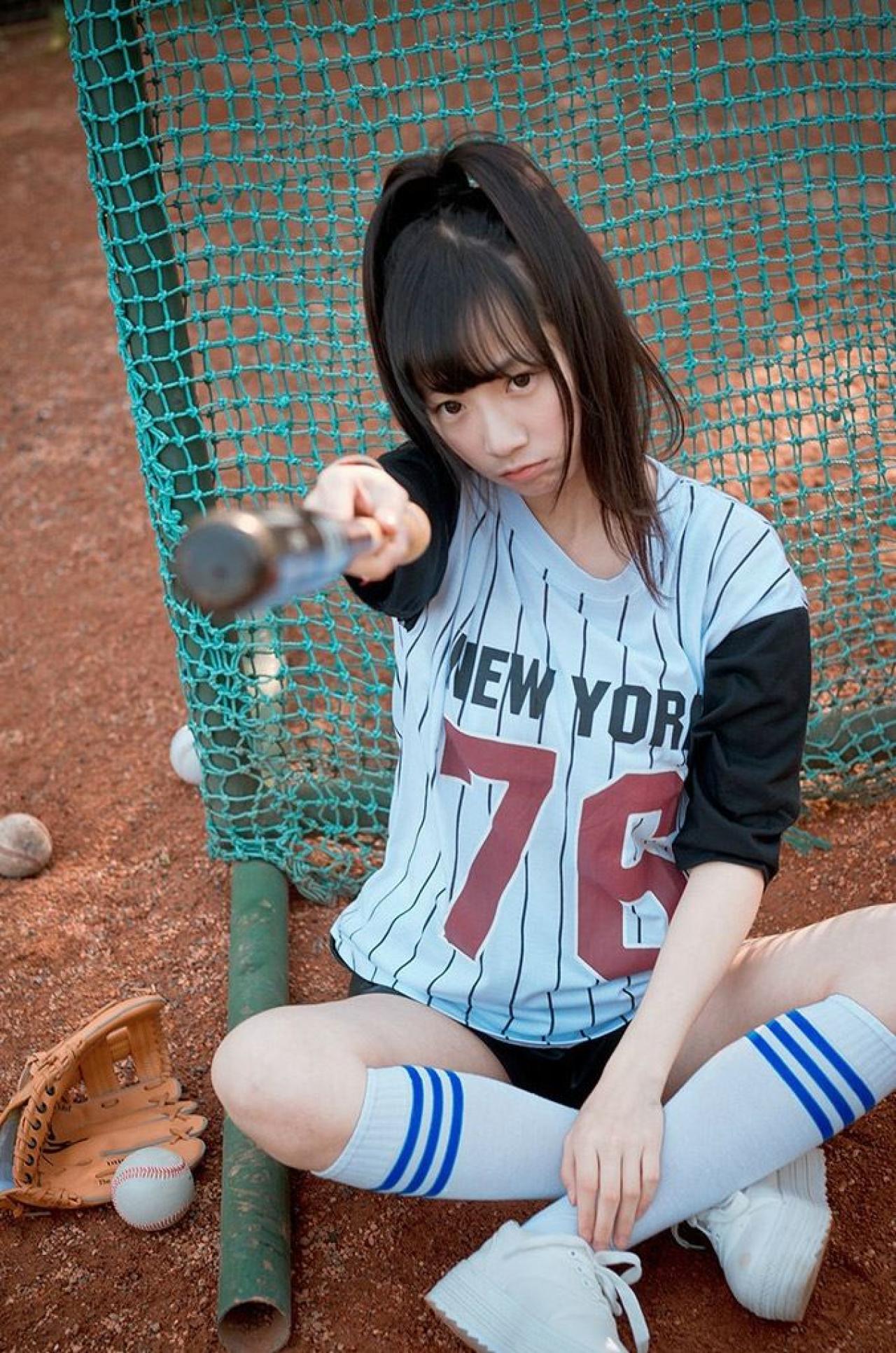 馋宝宝坐在棒球网前，伸出球棒，嘟嘴的模样
