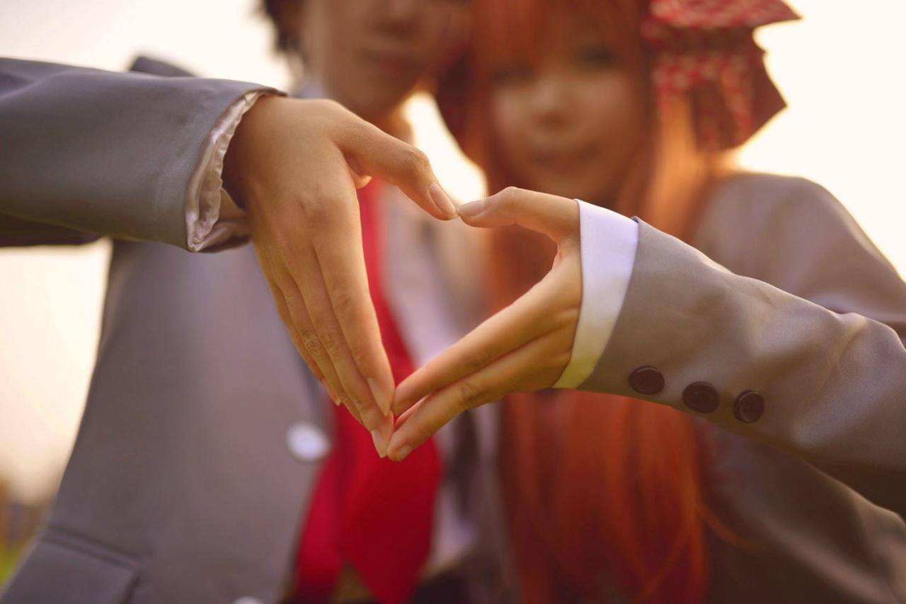 右手先生扮演的野崎梅太郎伸出右手，慕斯扮演的佐仓千代伸出左手，双手作心形手势