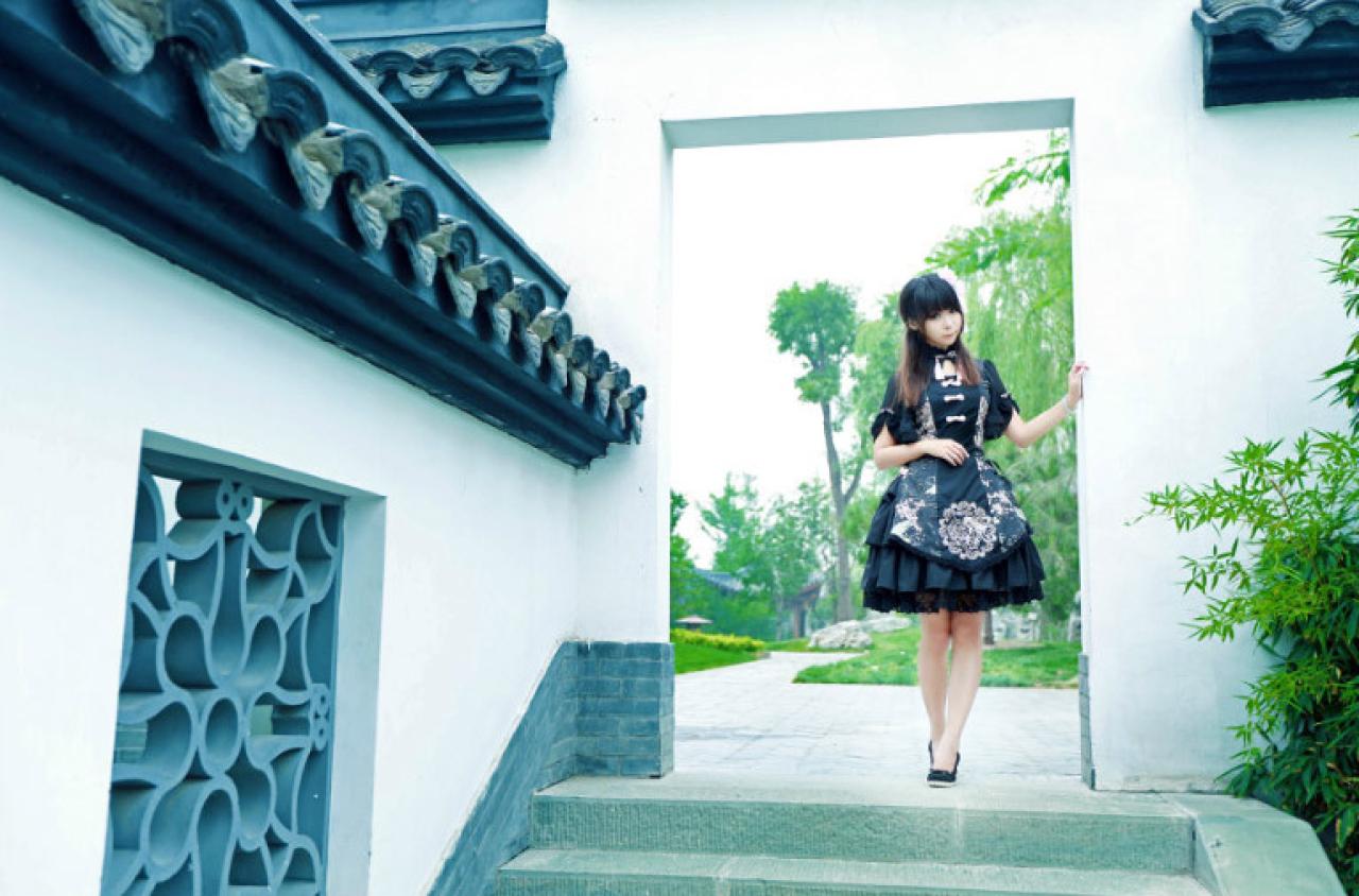 青梅素在白墙门口