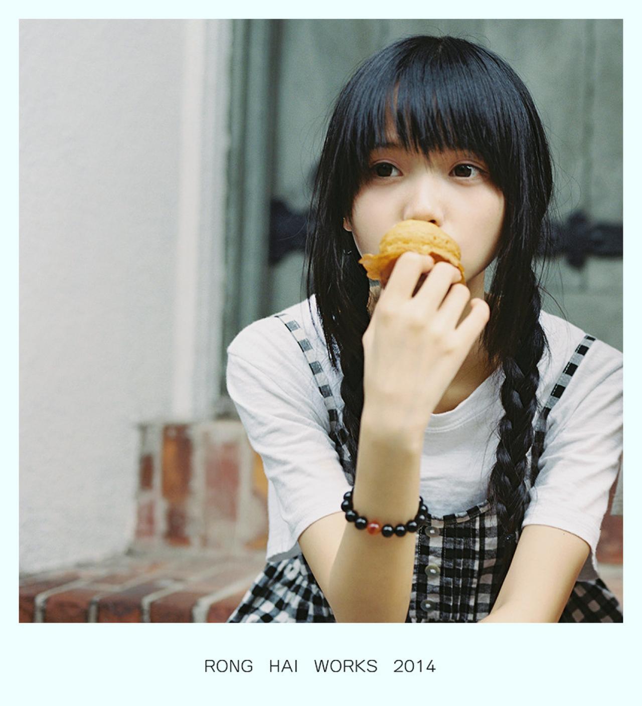 双马尾辫萌妹子坐在台阶上惬意的吃着蛋糕