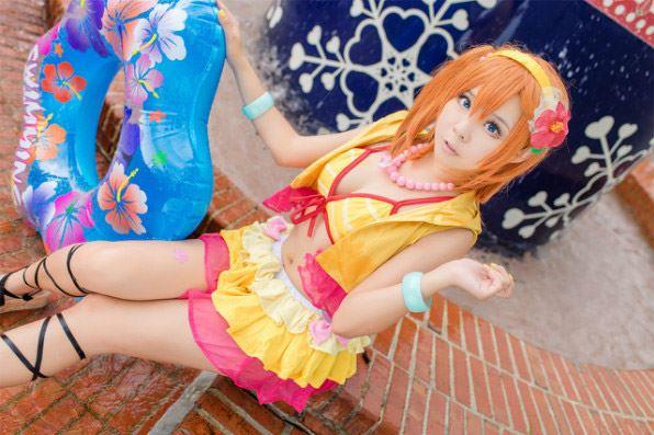 Candi糖糖扮演高坂穗乃果穿着黄色比基尼泳装，拿着泳圈坐在圆环台阶上