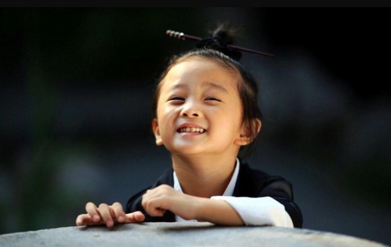 小道姑扒在石头上微笑的样子