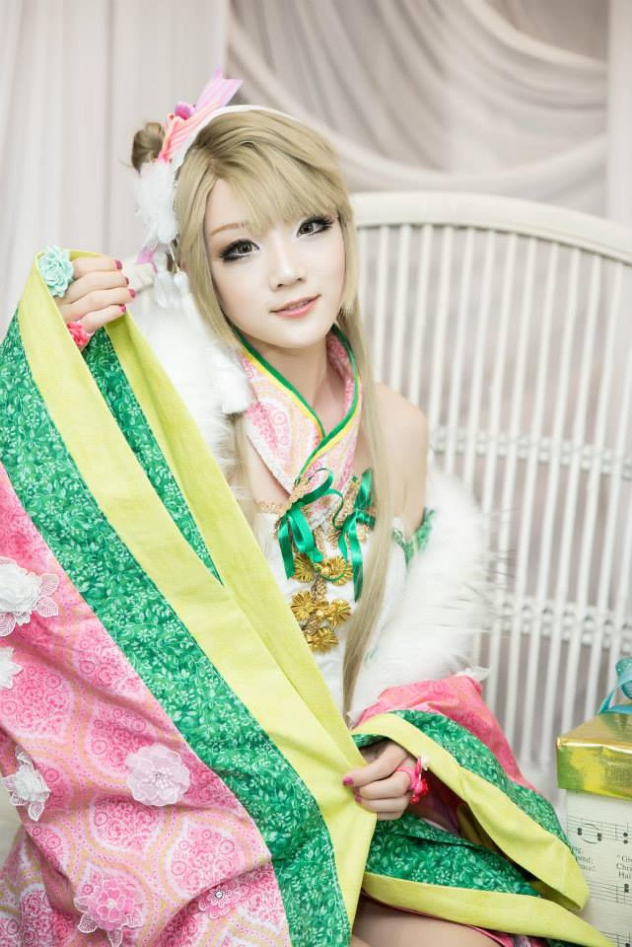 Miyuko扮演南小鸟抬起左手，右手拂袖的正面照