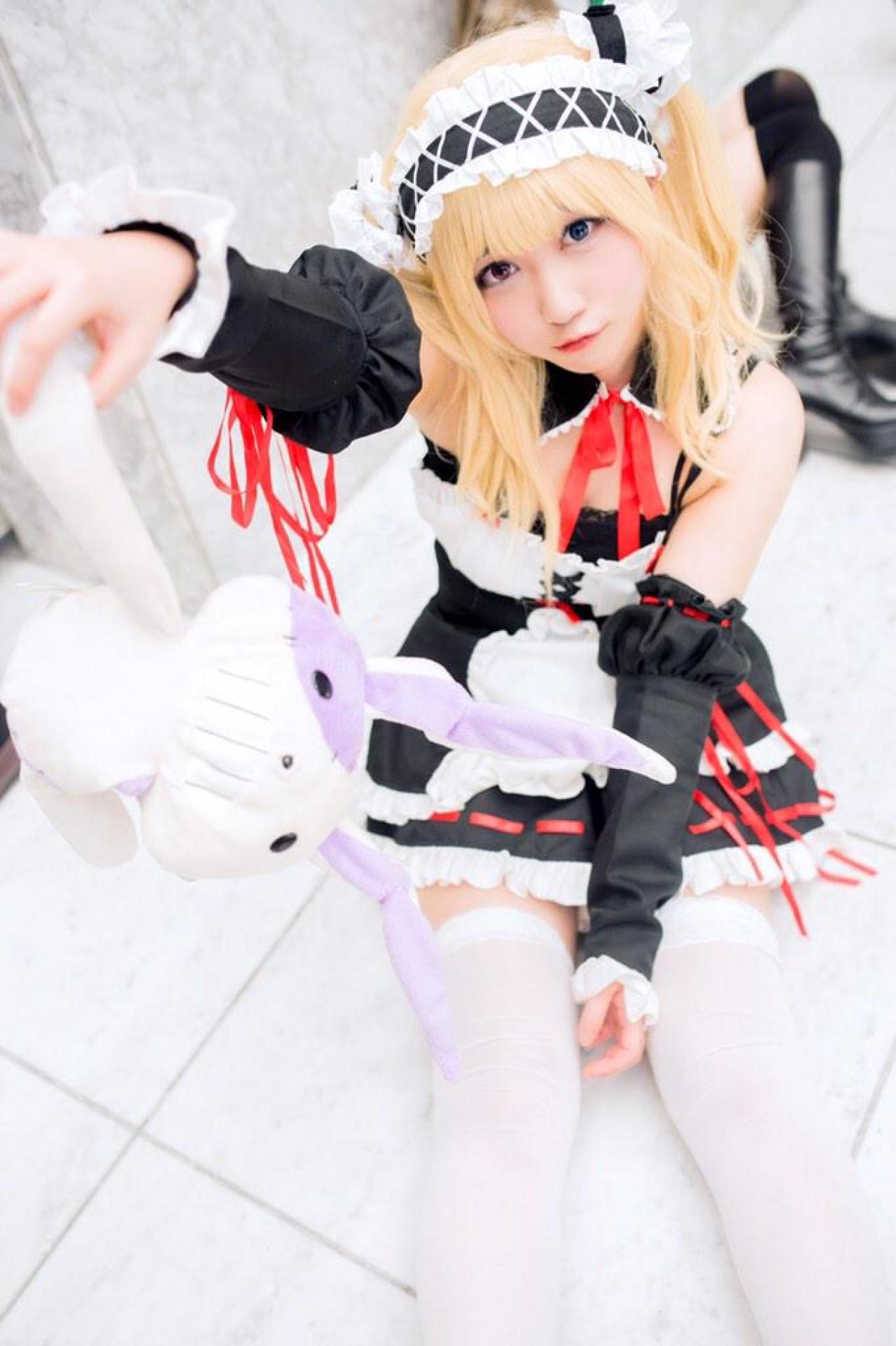 橘猫汰扮演羽濑川小鸠坐在地上拎起兔子玩偶的一只耳朵