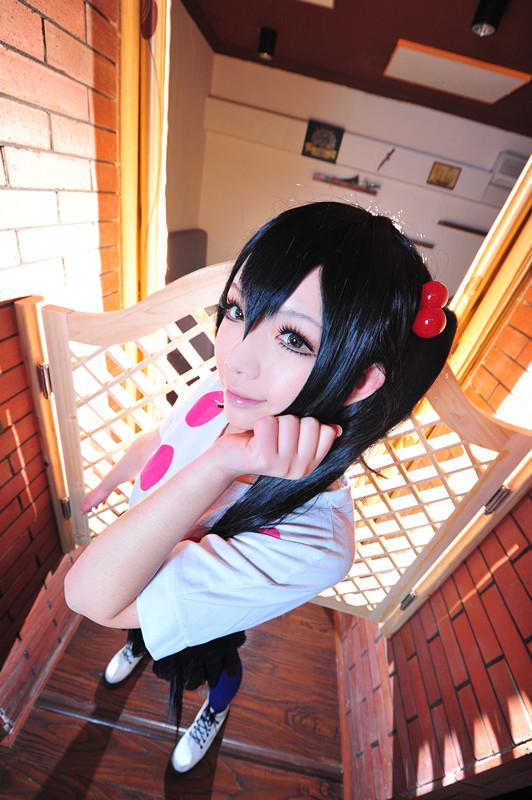 千叶泠扮演中野梓站在门旁，左手轻抚刘海儿