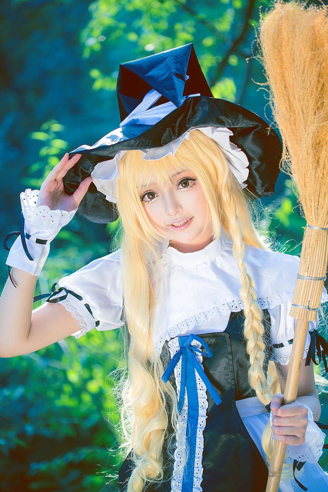 雨扮演雾雨魔理沙，左手握着扫把，右手扶着帽檐，站立的姿势