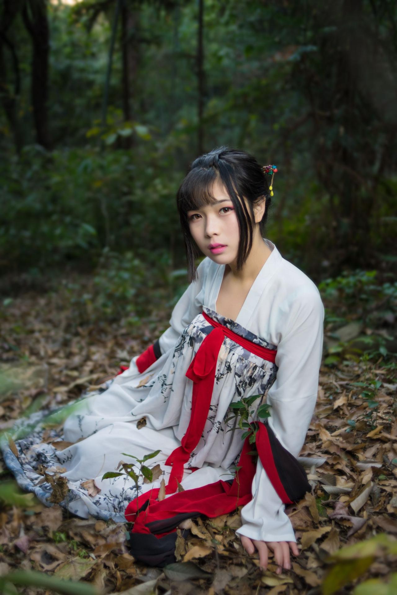 霓君侧身单手撑左在落叶之上