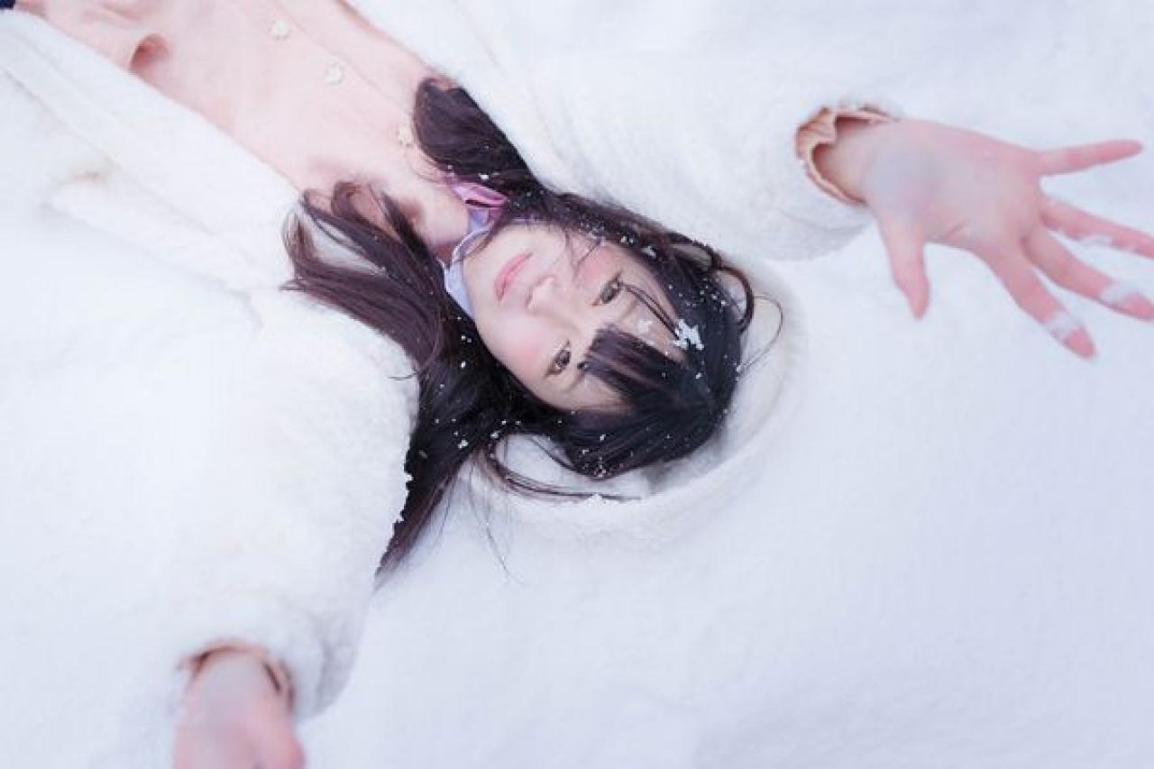 友利さん躺在雪地里，举起双手