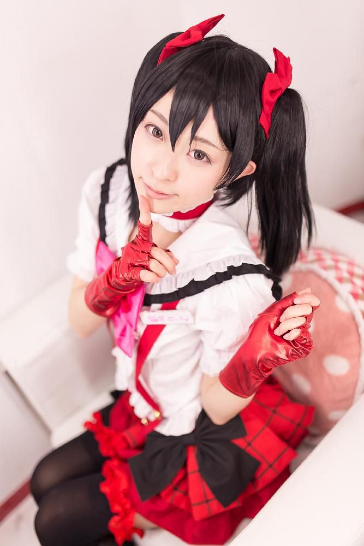 猫守ざーにゃ扮矢泽妮可坐在沙发，抬起左臂，右手食指抵着下巴