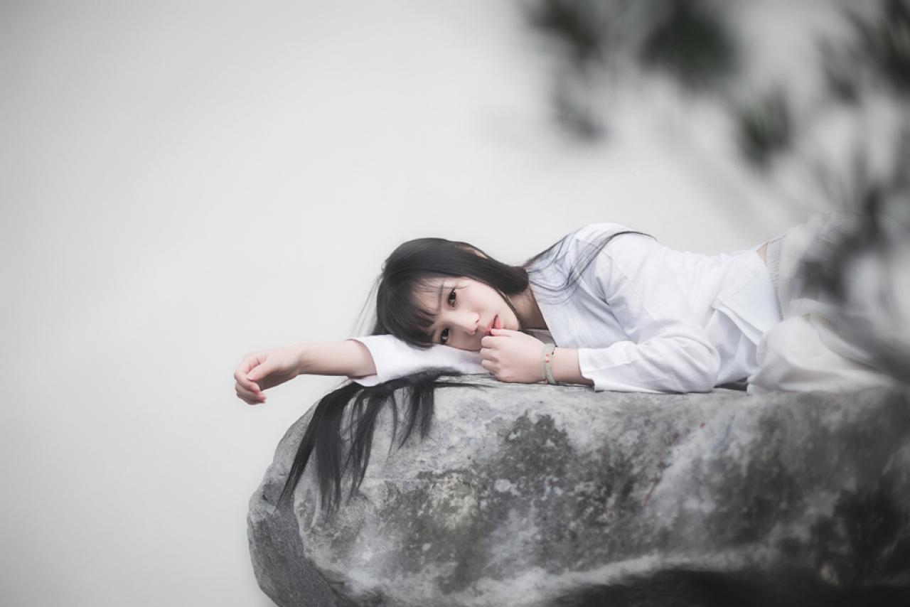 七七侧身扒在石头上