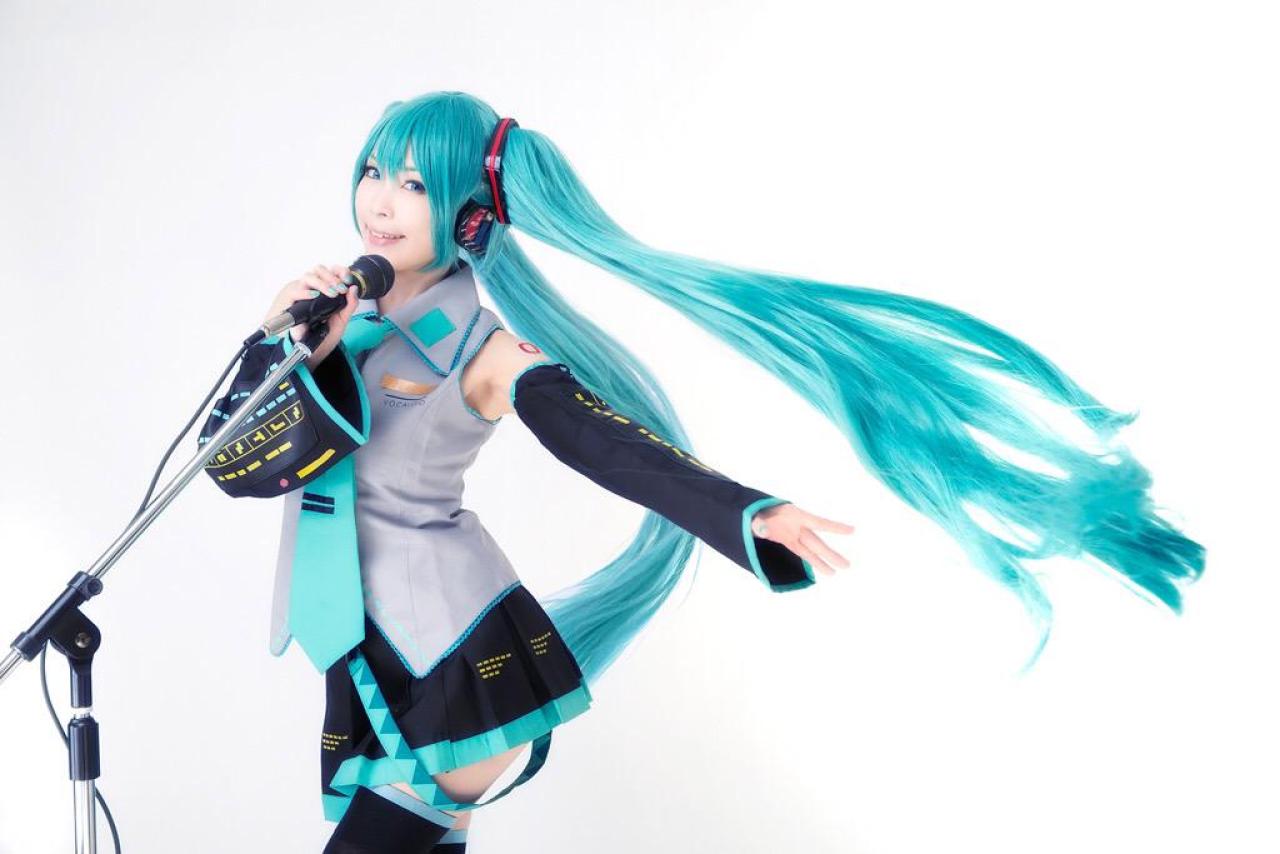ろき扮初音未来扶着话筒，长发飘逸