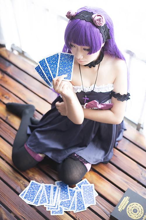 萌妹扮五更琉璃黑猫跪在地板上，右手捏着塔罗牌