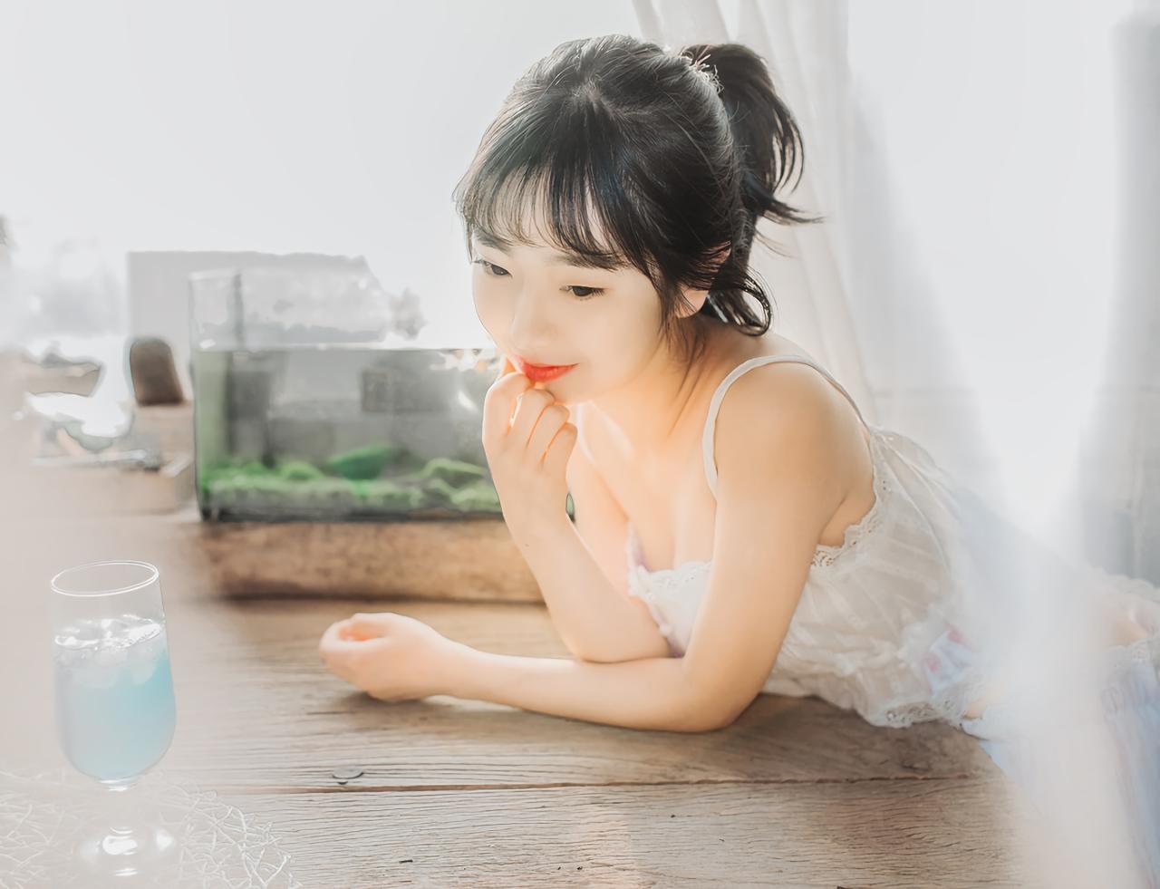 萌妹子趴在桌子上 3/4侧面 右手轻抚唇角