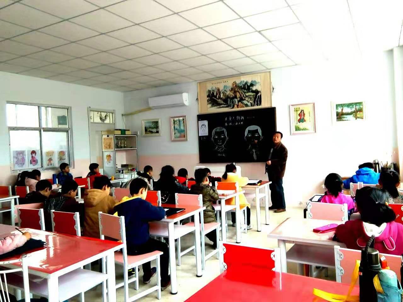 老师正在给一部初小班的学生讲解人物画